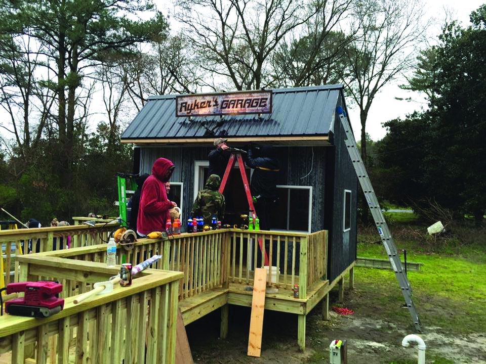 Members of the team build a wheelchair-accessible clubhouse for a child diagnosed with muscular dystrophy.