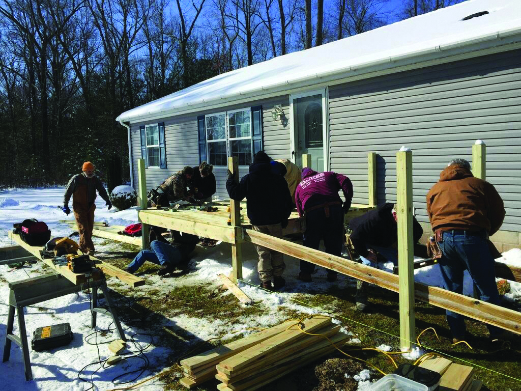 Good Ole Boy volunteers help build a wheelchair ramp  for someone in need.