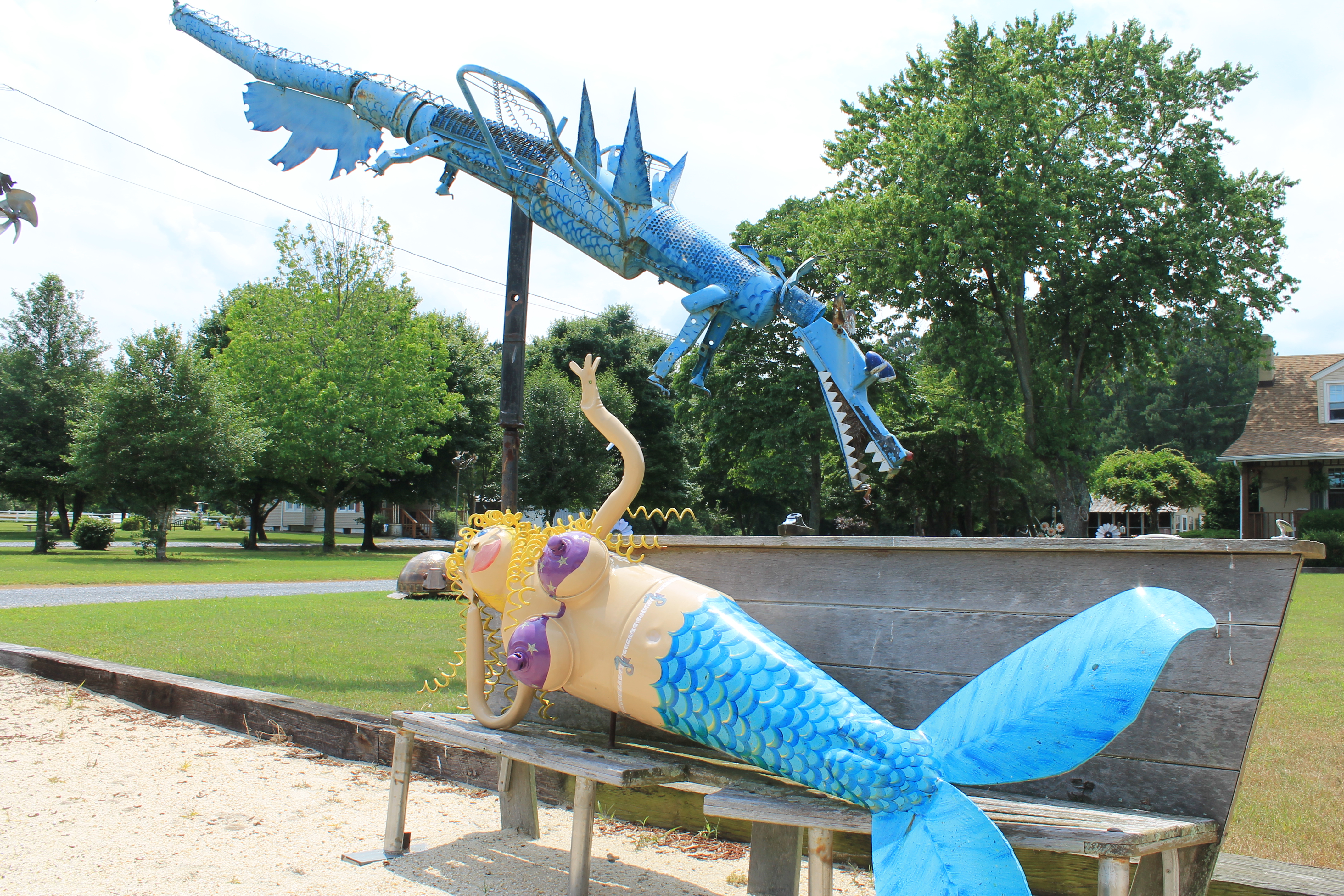 A metal mermaid and dragon.