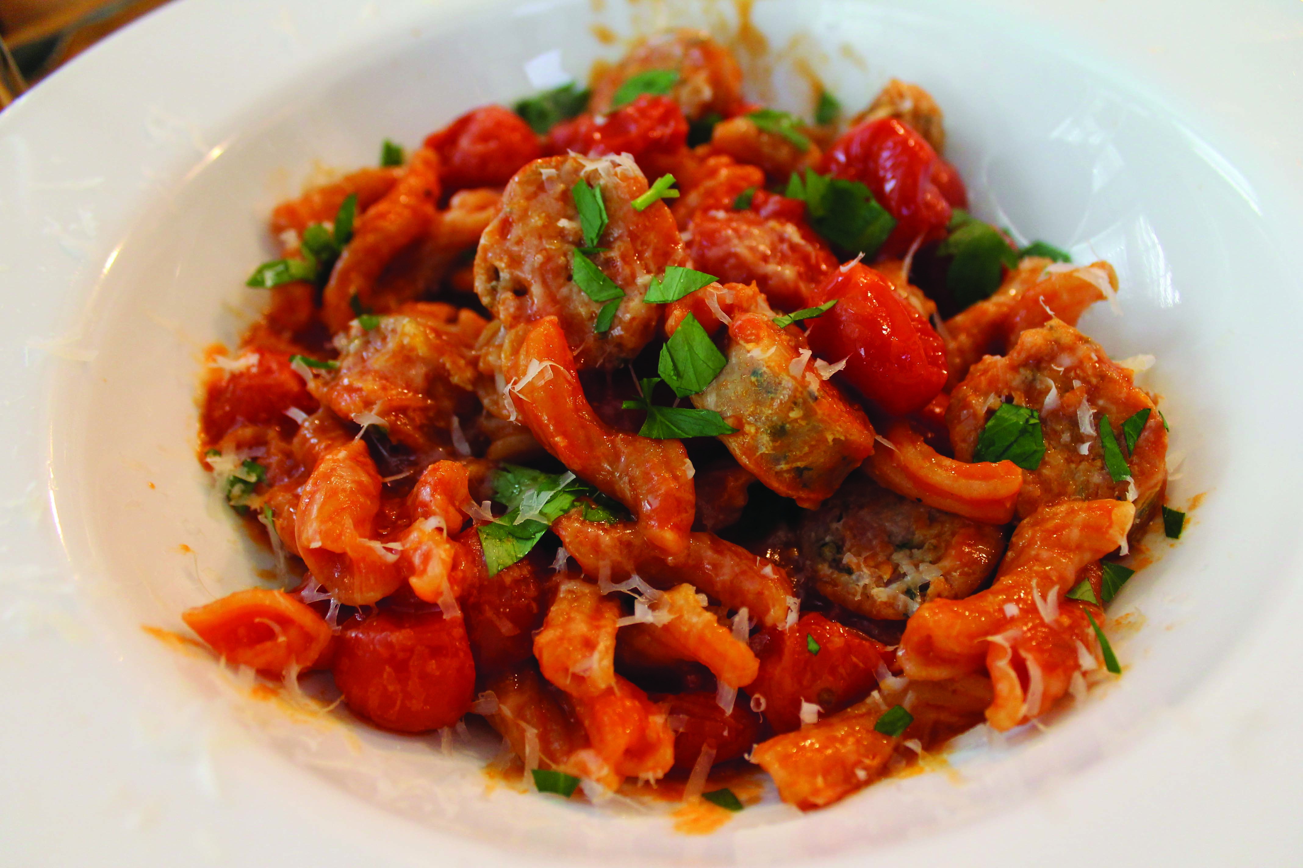A pasta dish made with Italian tomatoes, Parmesan, parsley, and Cullen's in-house chicken sausage