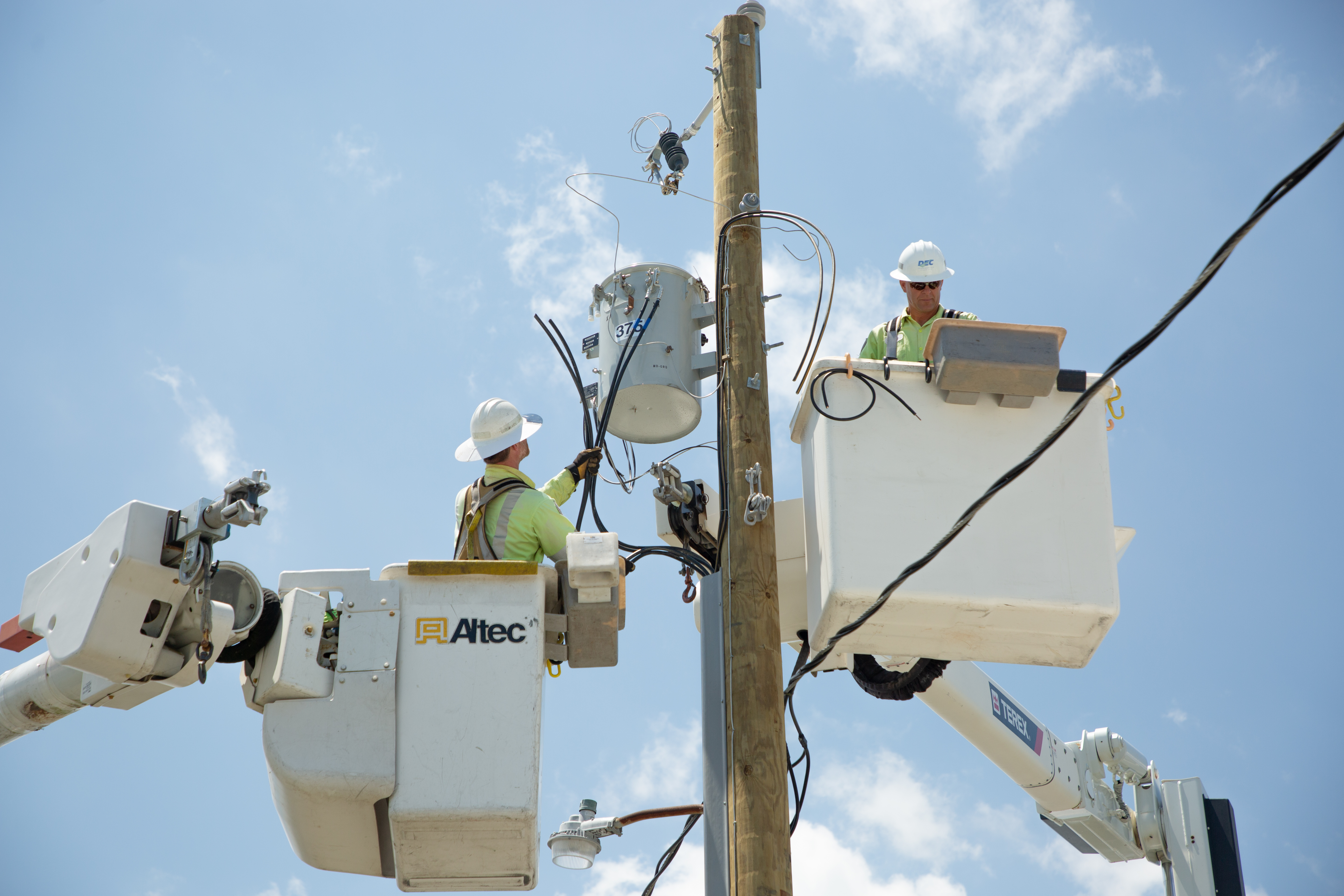 DEC Lineman work to restore power to members.