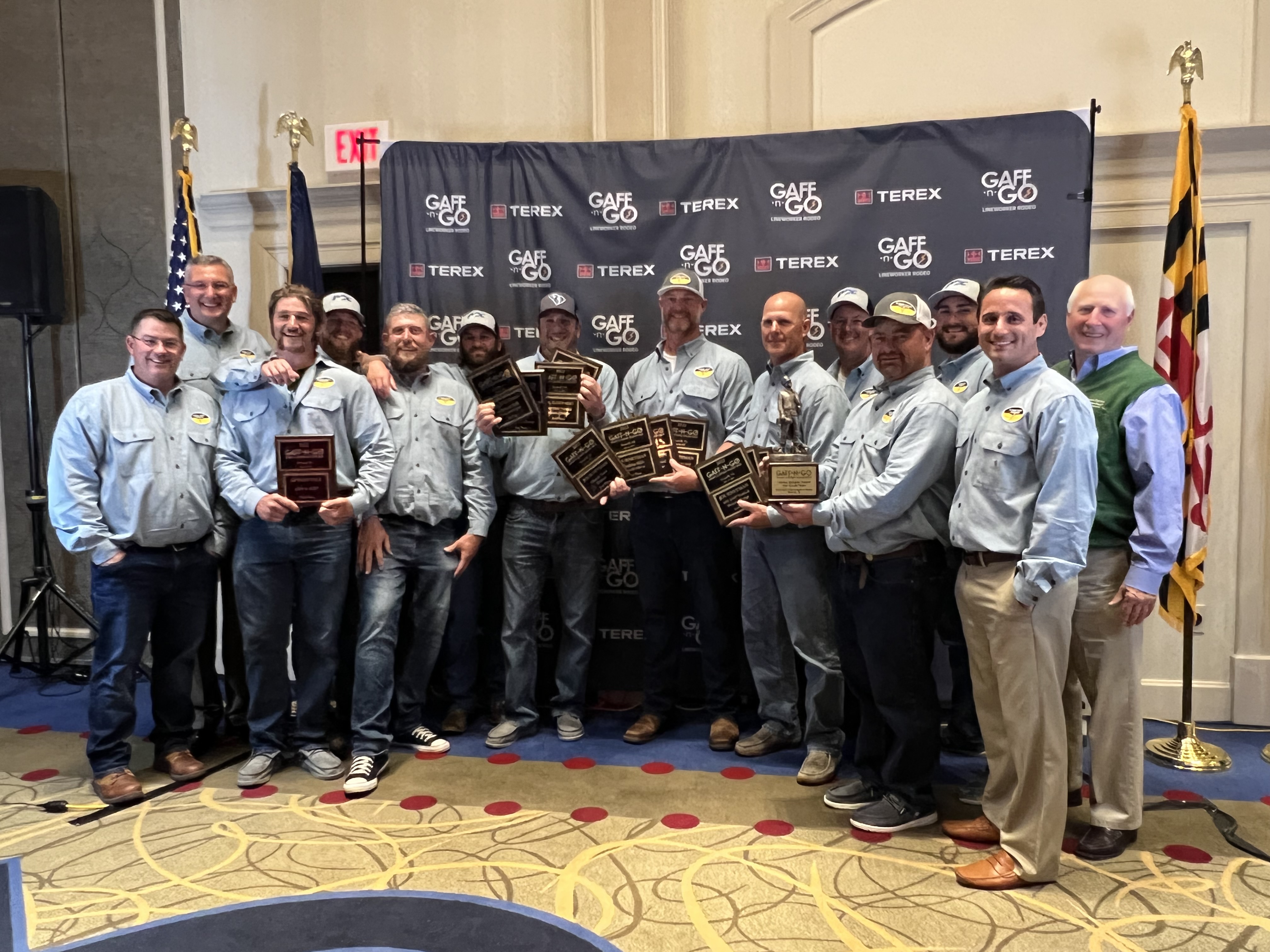 DEC's linemen team poses for photos with their awards at the Gaff-N-Go Lineworker Rodeo awards ceremony.