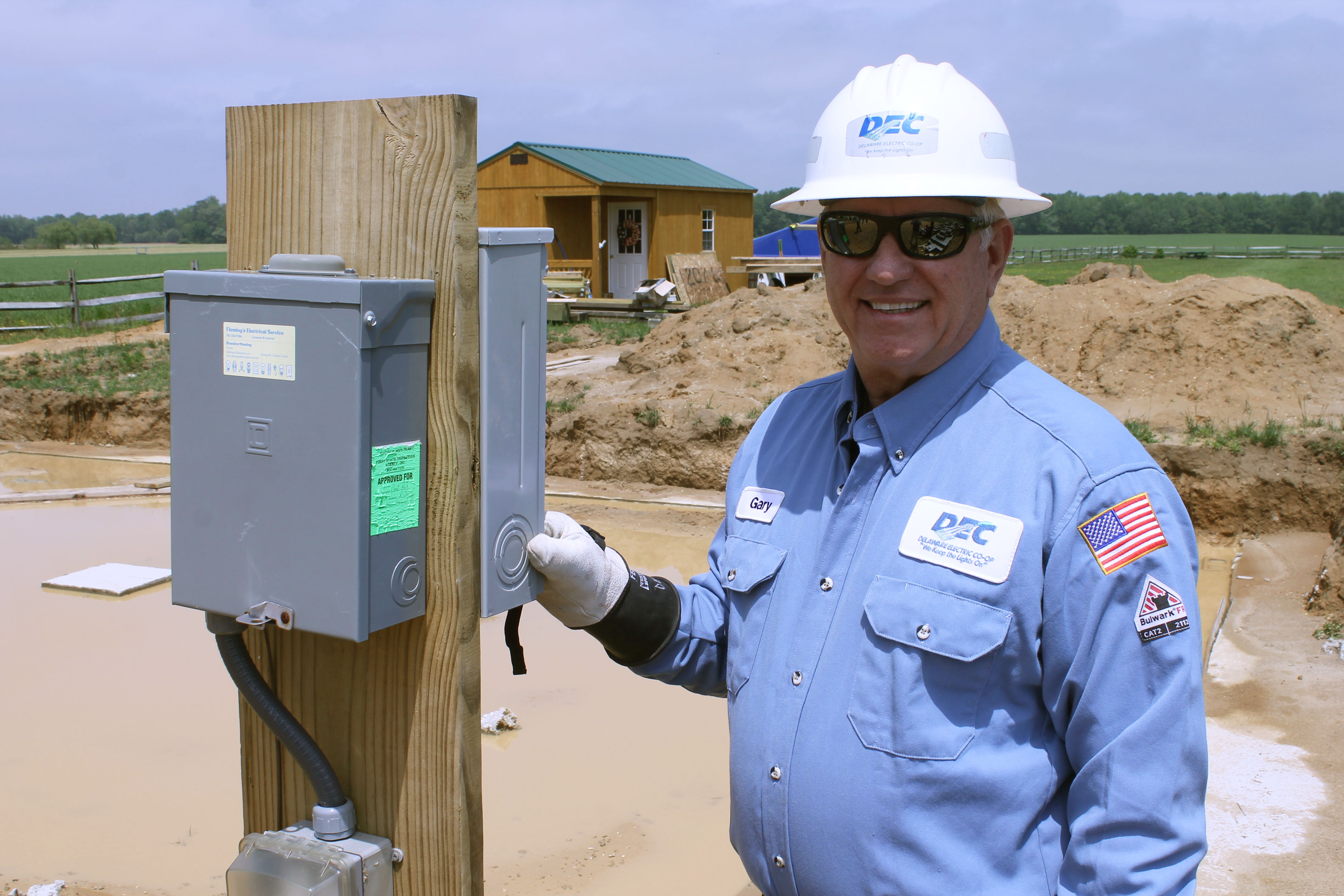 Senior Meter Technician Gary Pusey sets DEC's 100,000 meter.