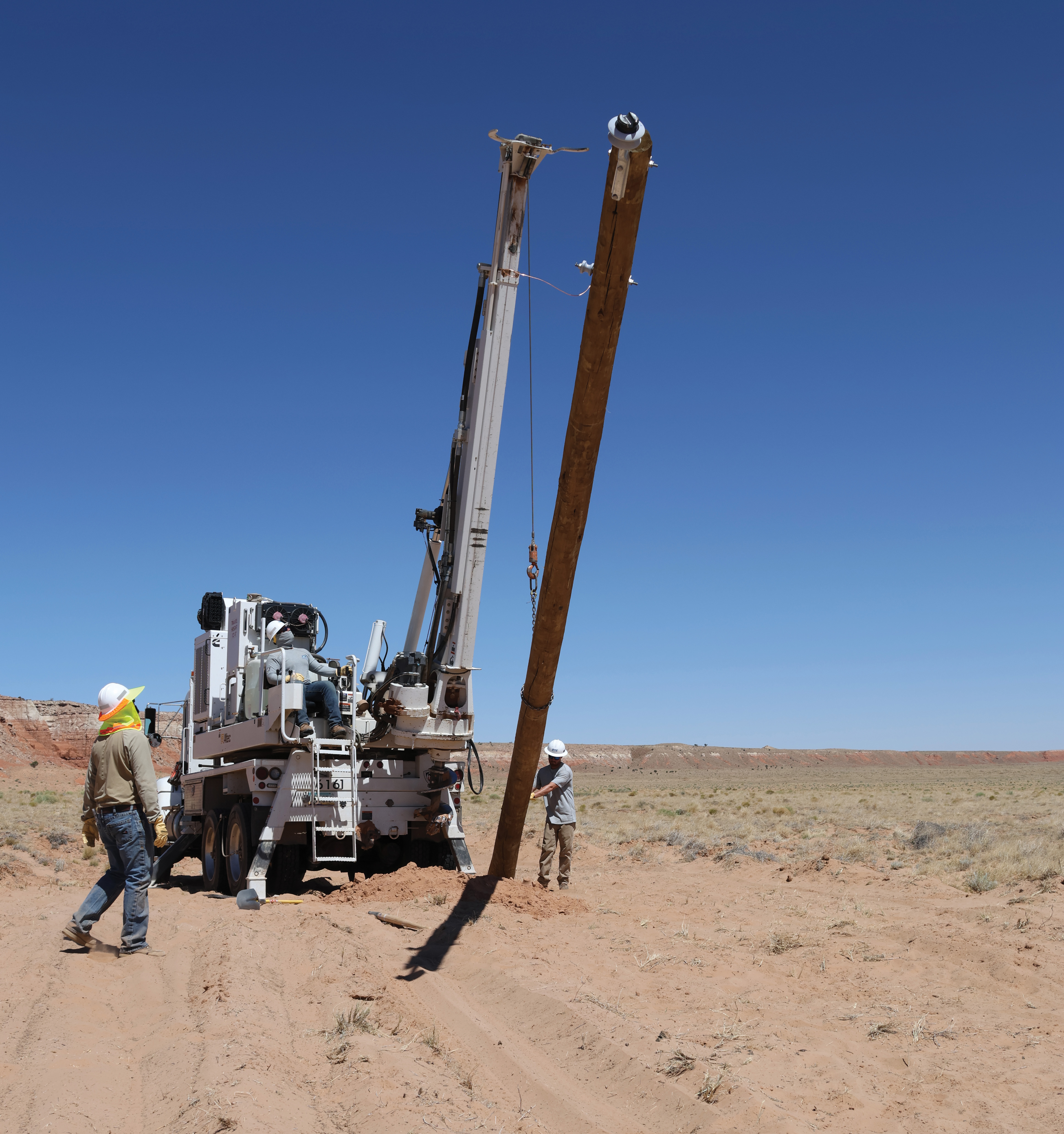 DEC lineworkers set a utility pole to bring electricity to a home in the Kayenta district in Arizona.