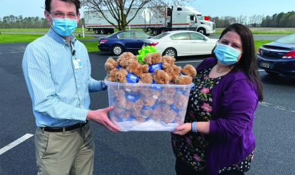 Two People Holdling Container of Bears
