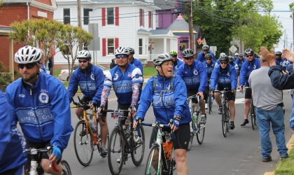 People in blue jackets on bicycles