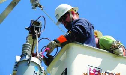 Man in bucket at top of pole