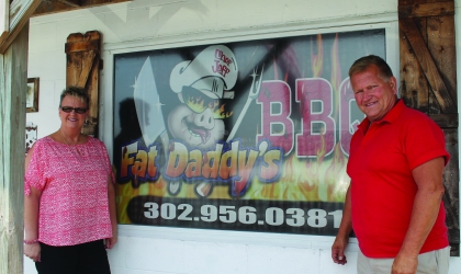 Fat Daddys Sign with two people