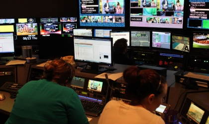 Room of screens and workers