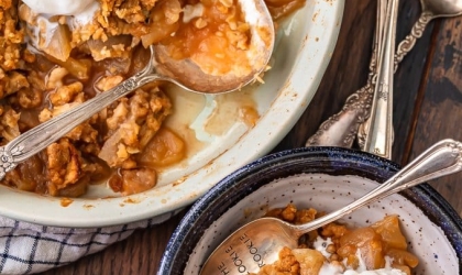 apple crisp in bowl with ice cream