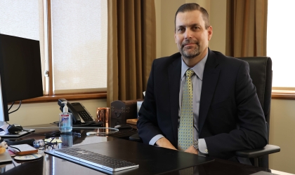 DEC President and CEO Rob Book poses for a photo at his desk.