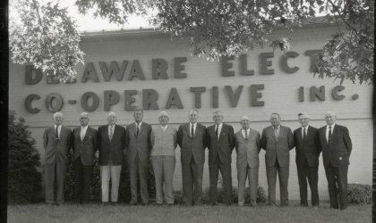 Founders of Delaware Electric Cooperative stand in front of the original headquarters building.