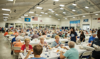 Members gather in Memorial Hall at the Delaware State Fairgrounds to enjoy a fried chicken dinner and community fair at DEC's Annual Meeting.