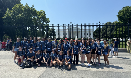Students participating in Youth Tour pose for a photo in front of the White House.