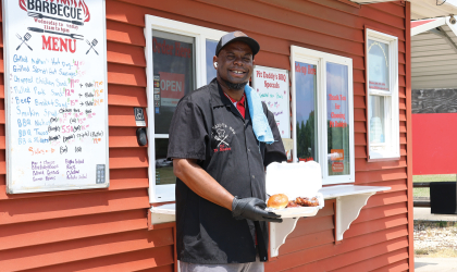 CJ Dickerson — owner of Pit Daddy's BBQ — photographed in front of his restaurant, which opened its doors in 2020.