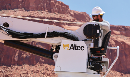 Lineworker Joshua Benedict works in the desert heat to set utility poles in the Navajo Nation.