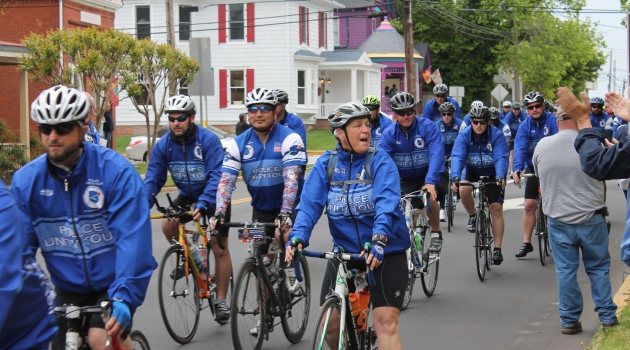 People in blue jackets on bicycles