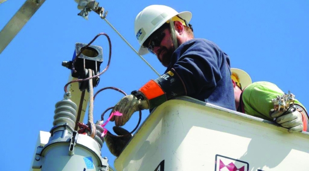 Man in bucket at top of pole