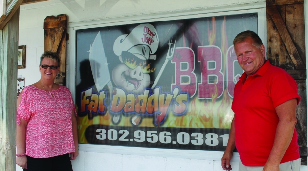 Fat Daddys Sign with two people