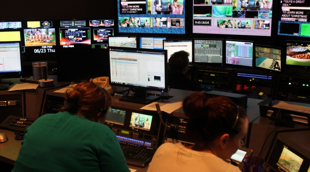 Room of screens and workers