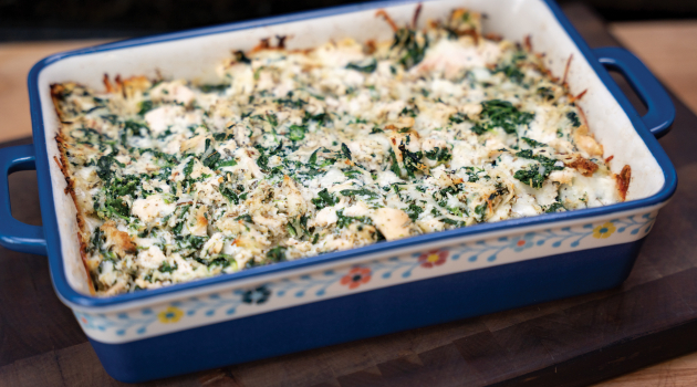 Photo of DEC's featured recipe: Cheesy Spinach Chicken Bake — prepared in a colorful, floral-themed casserole dish.
