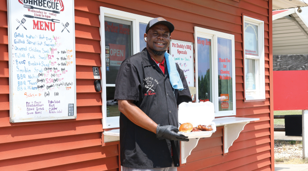 CJ Dickerson — owner of Pit Daddy's BBQ — photographed in front of his restaurant, which opened its doors in 2020.