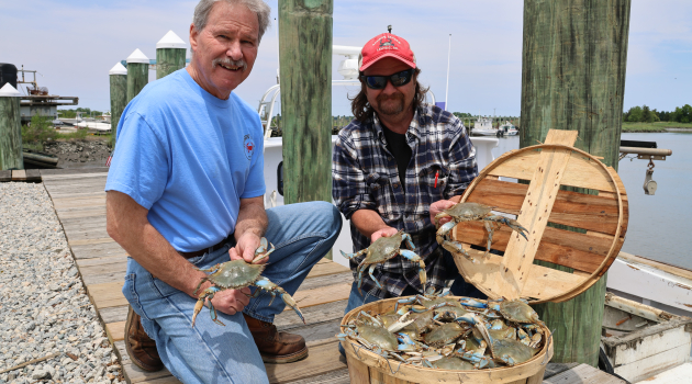 Todd Burrows (right) — owner of Sambo's Tavern in Leipsic — poses with his father Ike on the dock outside the family's restaurant.