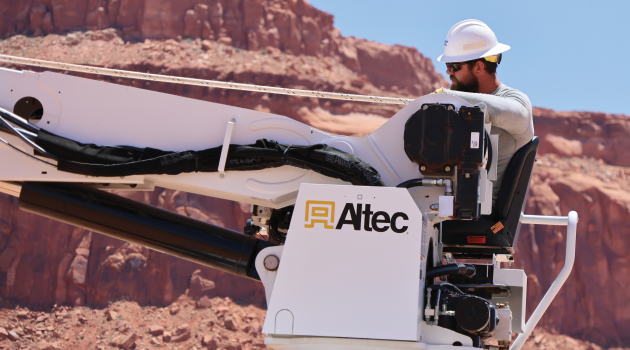 Lineworker Joshua Benedict works in the desert heat to set utility poles in the Navajo Nation.